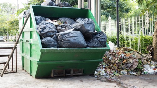 Staff loading separated recycling bins at a commercial office clearance in Cricklewood